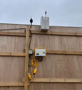 construction dust management tools on a wooden fence.